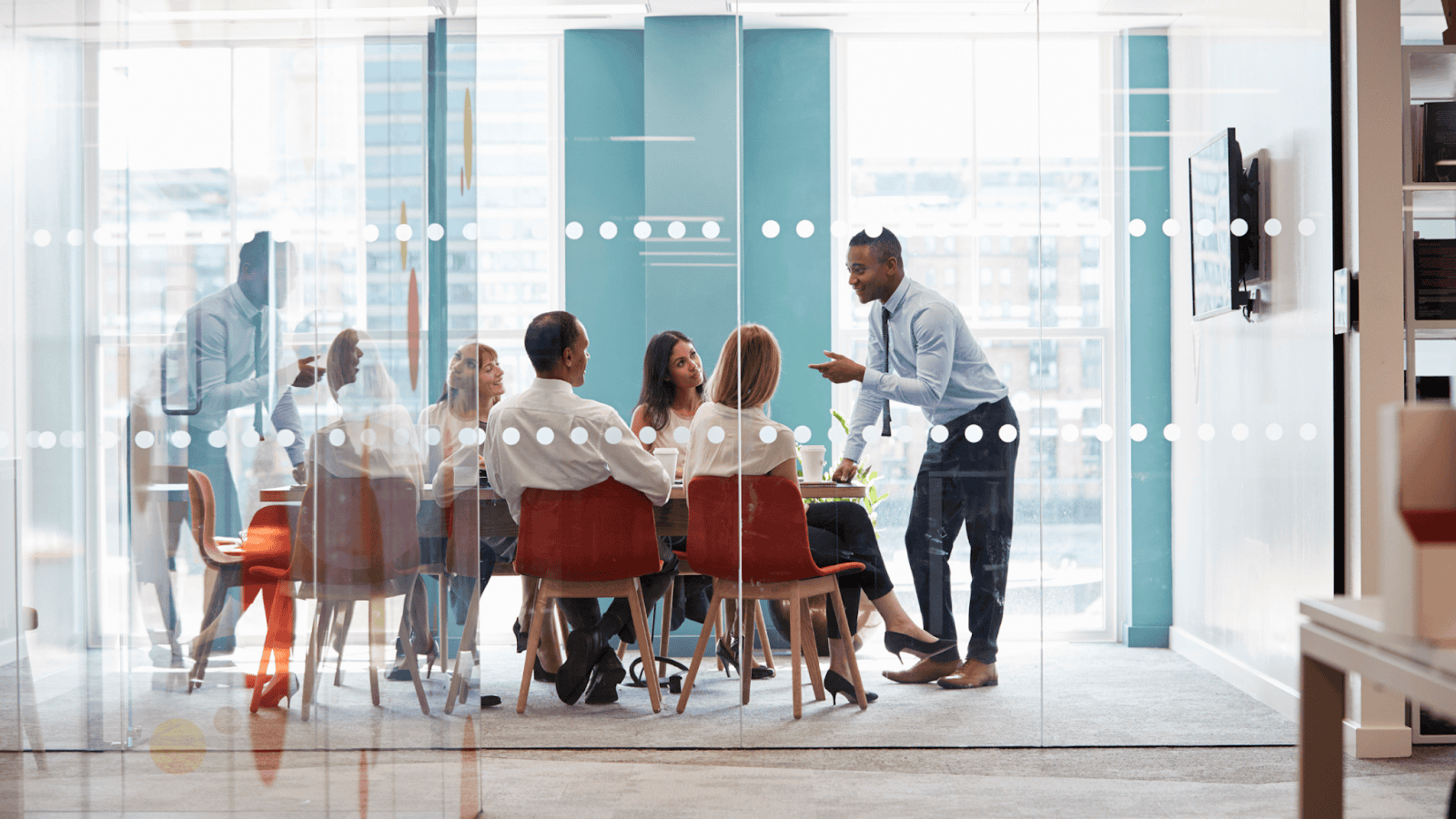Leadership coach guiding a diverse team in a meeting, illustrating collaboration, growth, and communication in leadership coaching.