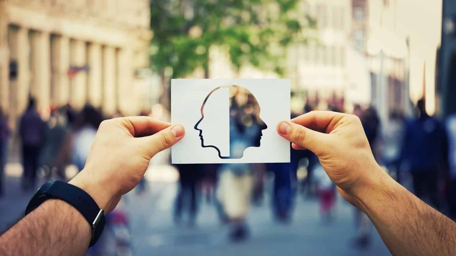 Symbolic image of two faces looking in opposite directions, symbolizing the emotional intelligence of understanding different personalities and adjusting one’s management style based on people’s diverse needs - a key trait of effective managers.