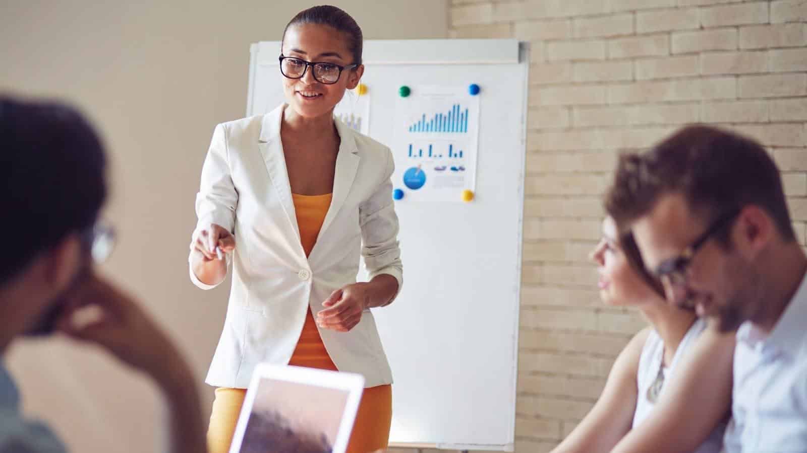 Confident manager leading a team presentation, demonstrating leadership, decision-making, and responsibility in management.